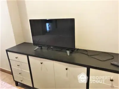 Modern bedroom with sleek TV on stylish cabinet, perfect for relaxation and entertainment.