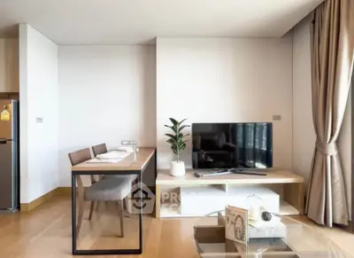 Modern living room with sleek furniture and natural light, featuring a TV and dining area.