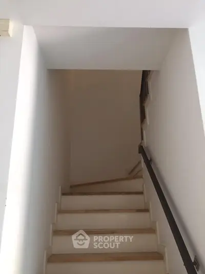 Minimalist staircase with sleek handrail in modern home interior