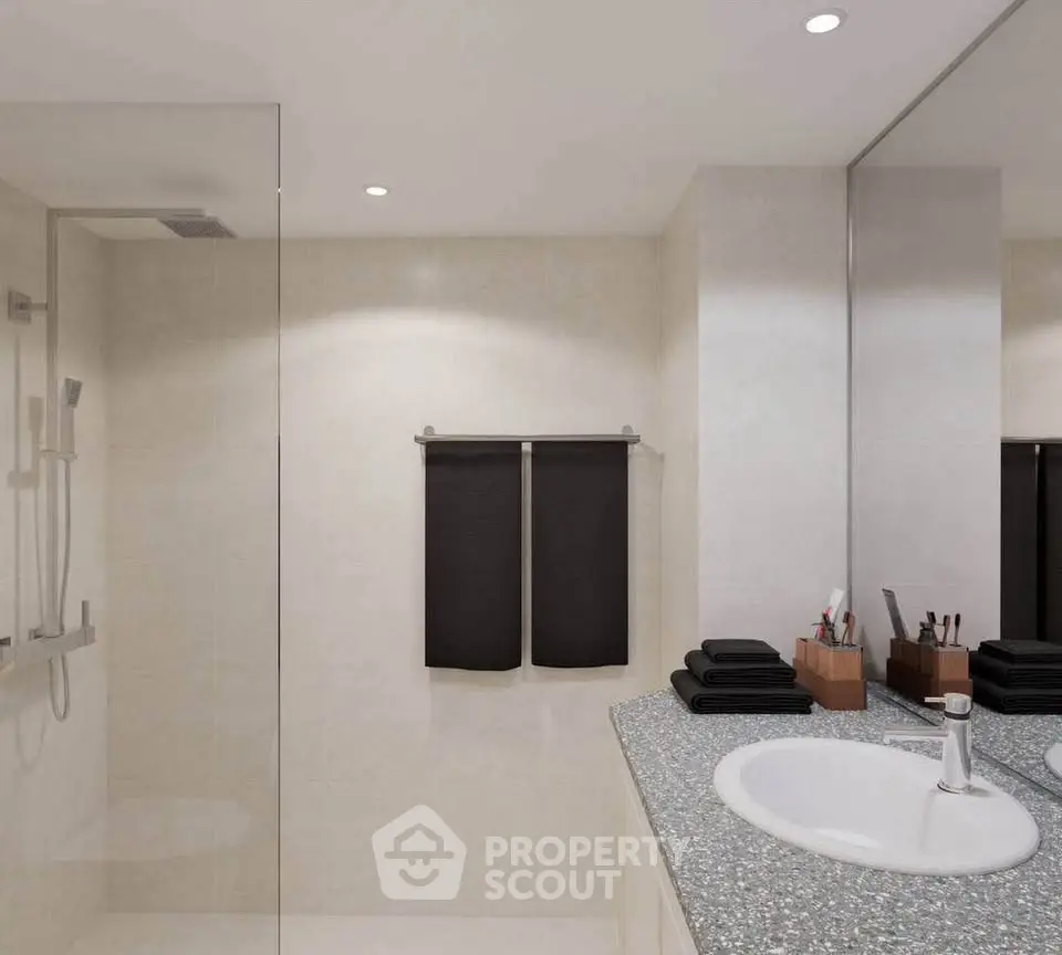 Modern bathroom with sleek design and elegant fixtures, featuring a spacious shower and stylish vanity.