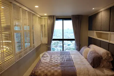 Luxurious bedroom with stunning city view, featuring elegant decor and cozy bedding.