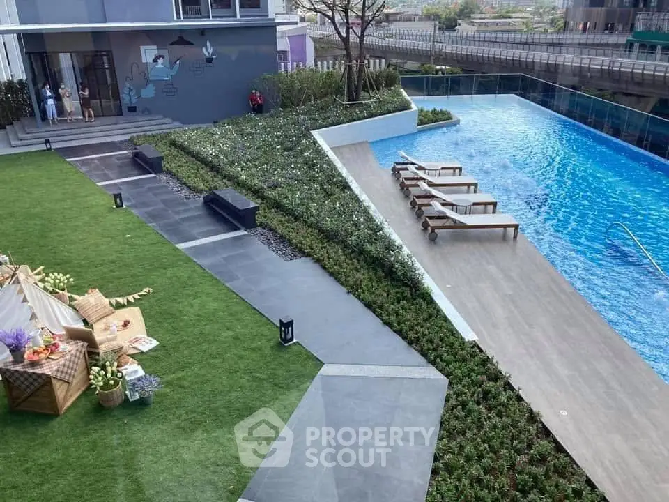 Luxurious apartment complex with stunning pool and landscaped garden area.