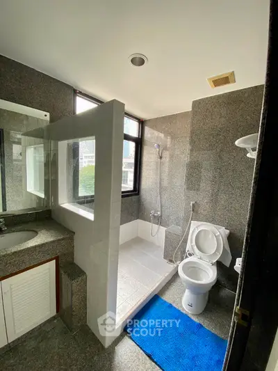 Spacious modern bathroom with large window and sleek design