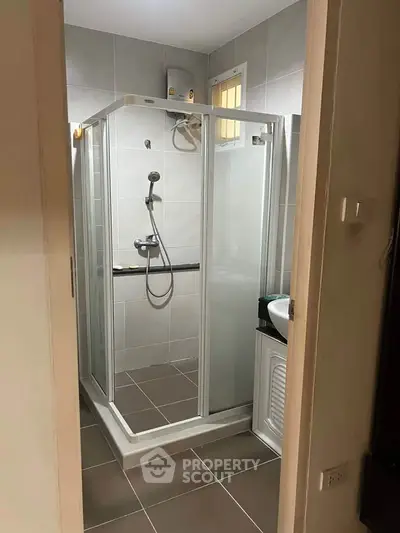 Modern bathroom with glass shower enclosure and sleek tile design
