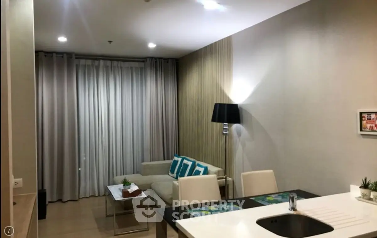Modern living room with stylish decor and open layout, featuring elegant furniture and ambient lighting.
