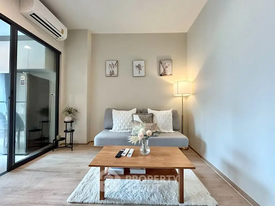 Modern living room with cozy sofa, stylish decor, and natural light in a contemporary apartment.