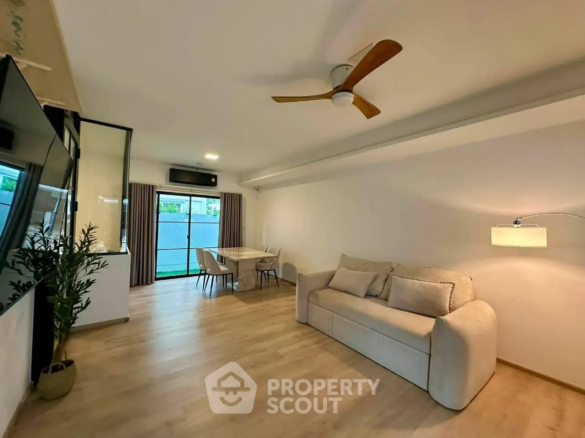 Spacious modern living room with elegant decor and large windows for natural light.
