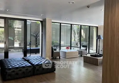 Modern living room with large windows and stylish furniture in a contemporary home.