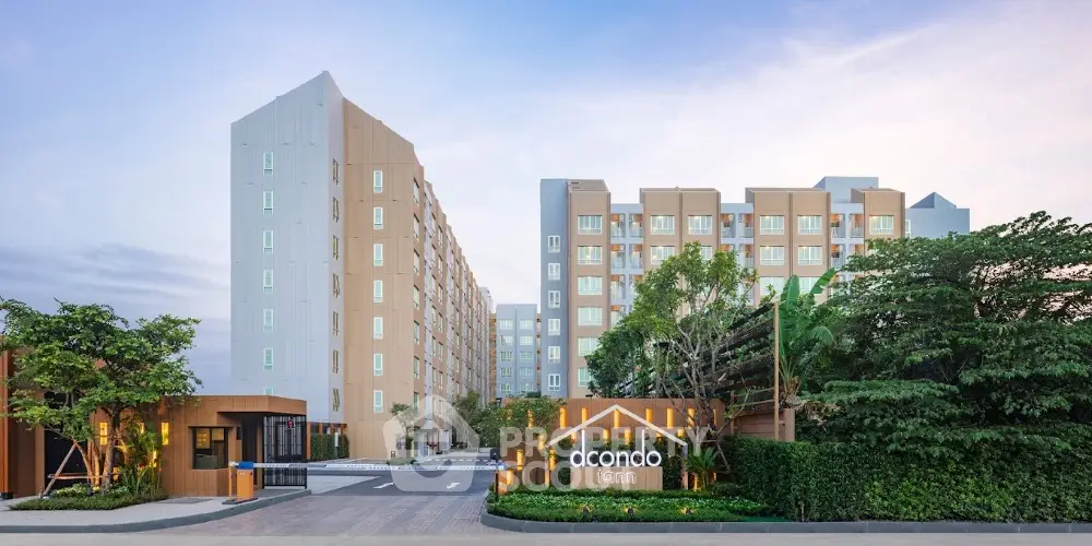 Modern condominium exterior with lush greenery and stylish entrance signage