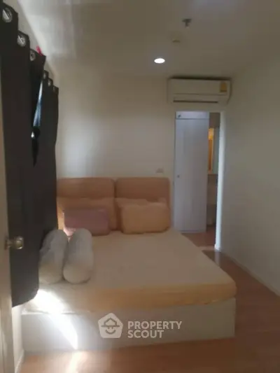 Cozy bedroom with air conditioning and soft lighting, perfect for relaxation.