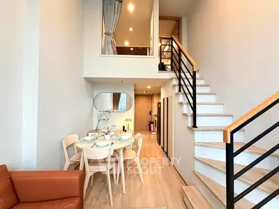 Modern duplex apartment with stylish dining area and staircase