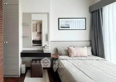 Modern bedroom with stylish decor and natural light, featuring a cozy bed and elegant furnishings.