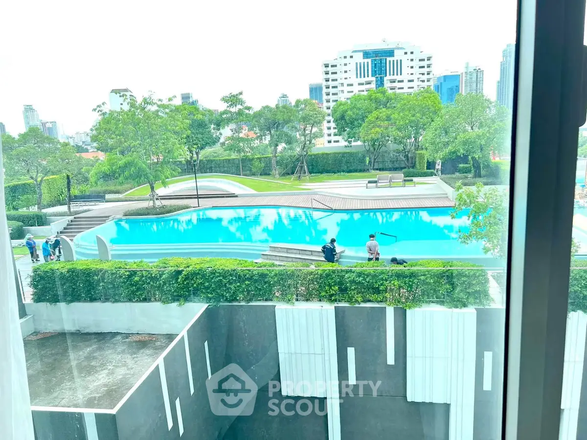 Luxurious urban apartment with stunning pool view and lush greenery, perfect for modern living.