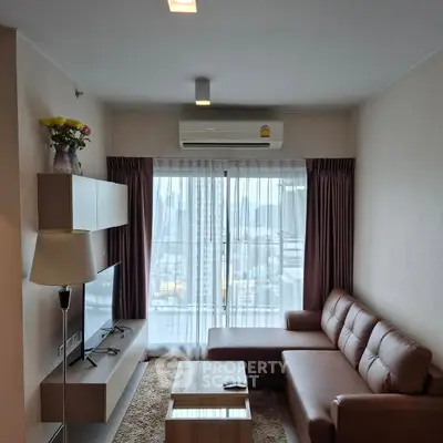 Modern living room with leather sofa and city view through large window