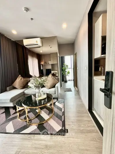 Modern living room with stylish decor and open layout, featuring a cozy sofa and chic coffee table.