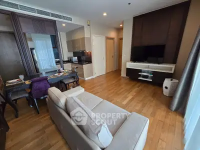 Spacious modern living room with open kitchen and elegant dining area in a stylish apartment.