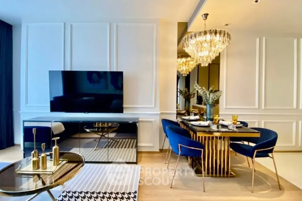 Luxurious living room with elegant dining area, featuring a large TV, chic chandelier, and stylish decor.