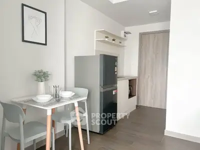 Modern kitchen with sleek fridge and dining area in stylish apartment