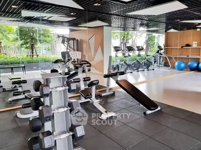 Modern gym with state-of-the-art equipment and lush garden view