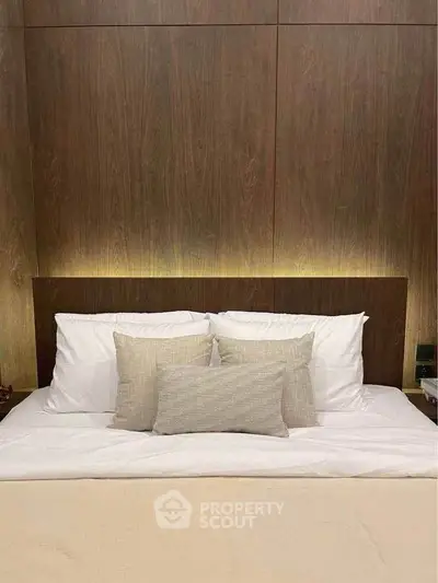 Luxurious bedroom with elegant wooden paneling and plush bedding