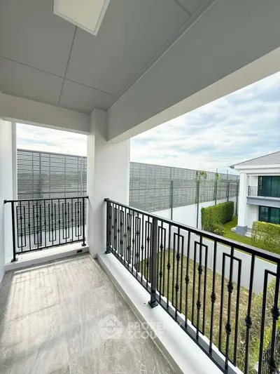 Spacious balcony with elegant railing and scenic view in modern property.