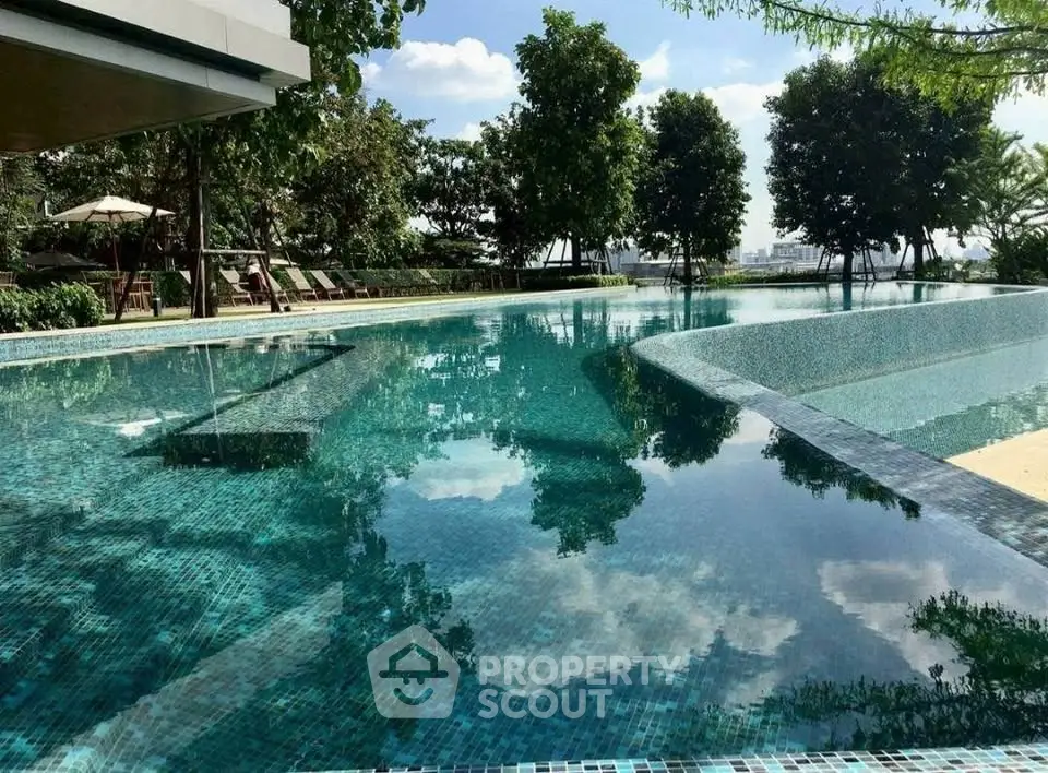 Luxurious outdoor pool with serene surroundings and lush greenery