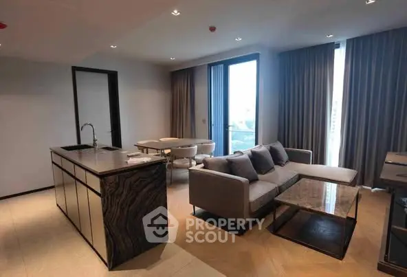 Modern living room with open kitchen and stylish furniture in a luxurious apartment.