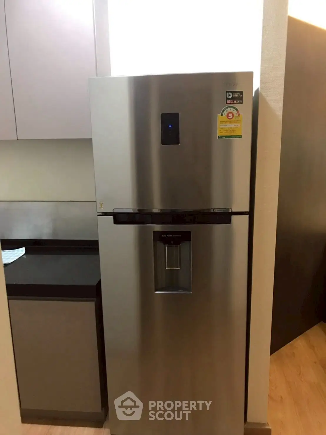 Modern kitchen with sleek stainless steel refrigerator and minimalist design.