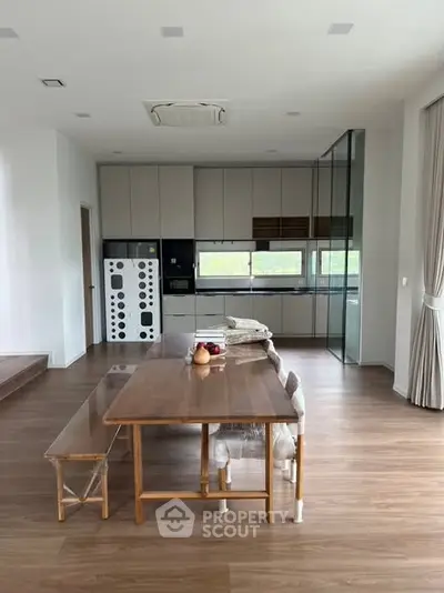 Modern kitchen with open layout and sleek wooden flooring