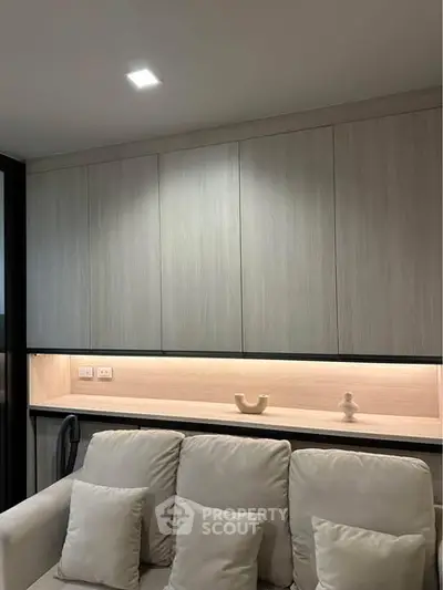 Modern living room with sleek cabinetry and cozy white sofa