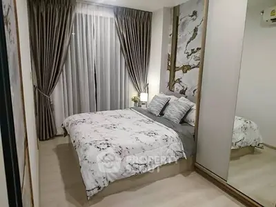 Modern bedroom with elegant decor and floor-to-ceiling curtains