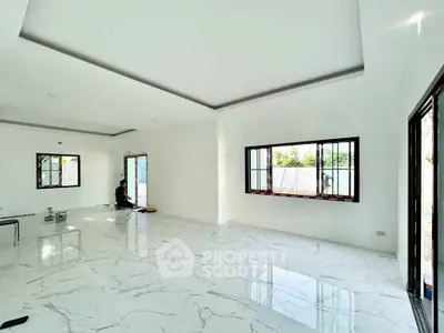 Spacious modern living room with marble flooring and large windows