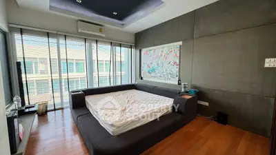 Modern bedroom with large windows and stylish decor