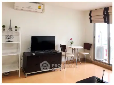 Modern living room with TV, dining set, and air conditioning in bright apartment.