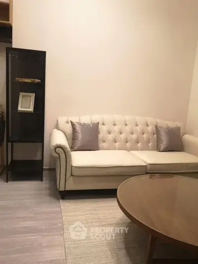 Cozy living room with elegant beige sofa and modern glass cabinet
