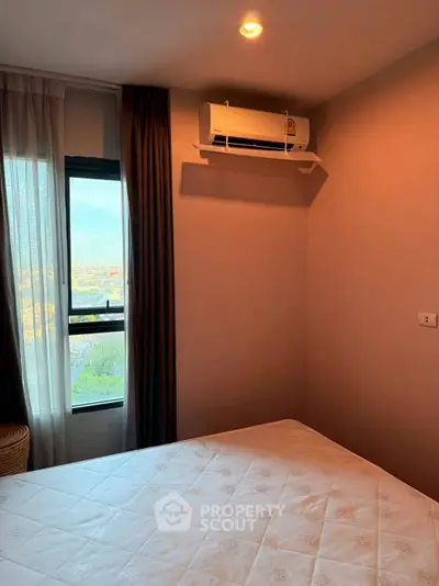Cozy bedroom with city view and air conditioning unit