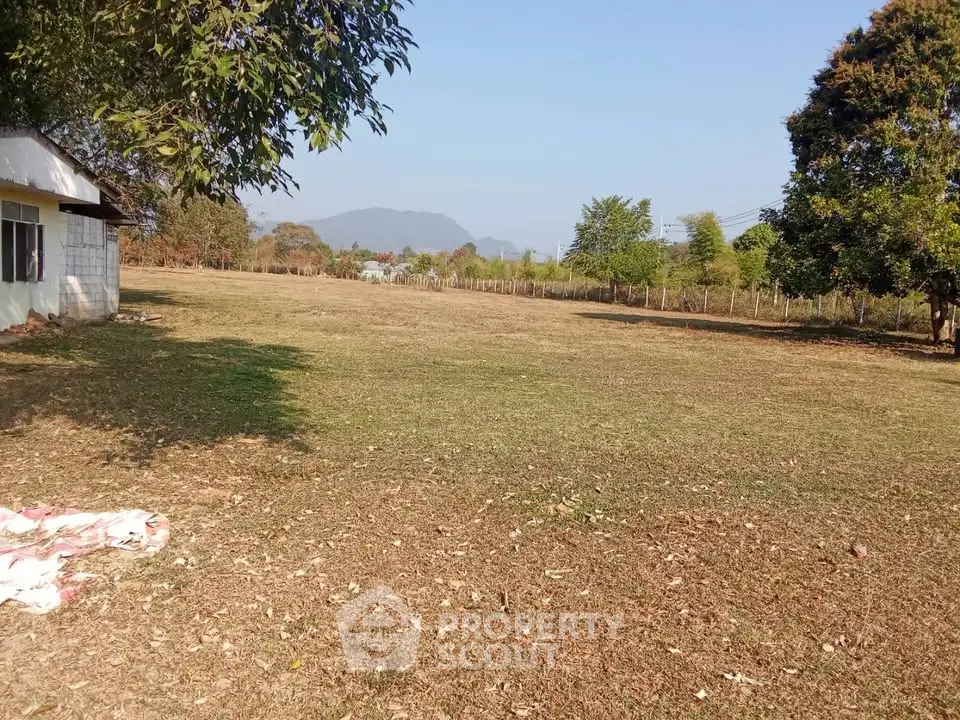 Expansive land plot with scenic mountain views, ideal for development or agriculture.