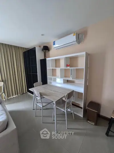 Modern living room with sleek furniture and air conditioning, perfect for comfortable urban living.