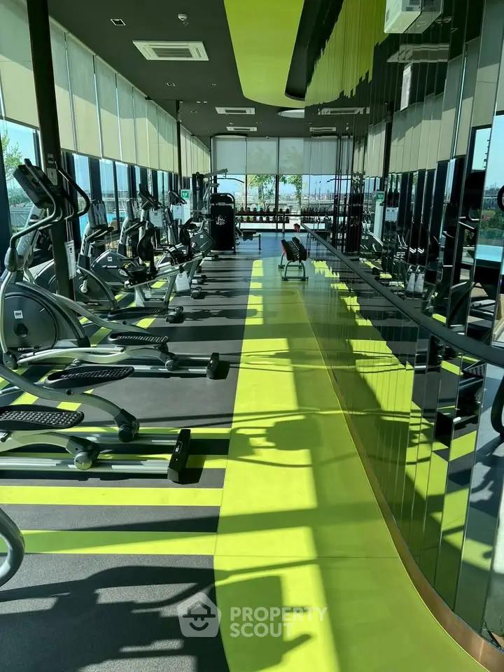 Modern gym with state-of-the-art equipment and panoramic windows offering stunning views.