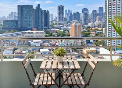 Stunning cityscape view from a modern balcony with stylish outdoor furniture.