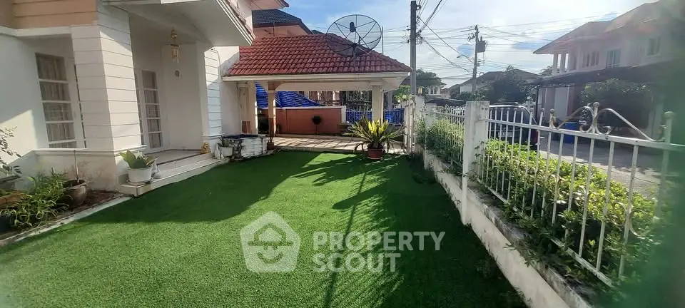 Charming suburban home with lush green garden and spacious driveway.