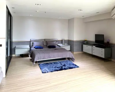 Spacious modern bedroom with elegant decor and ample natural light