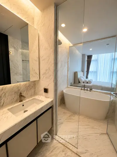 Luxurious bathroom with marble finishes and a freestanding bathtub in a modern apartment.