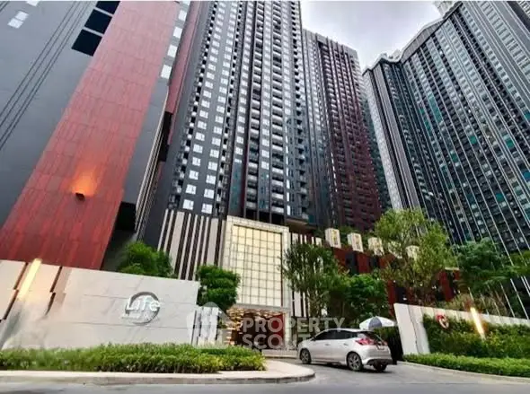 Modern high-rise residential building with lush greenery and sleek design