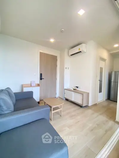Modern living room with sleek furniture and air conditioning in a cozy apartment.