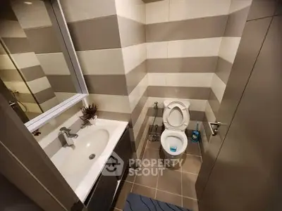 Modern bathroom with sleek design and striped wall tiles