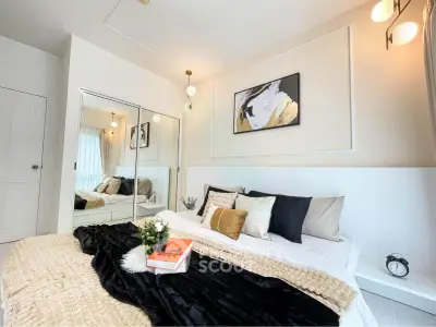 Luxurious bedroom with elegant decor and cozy ambiance, featuring a stylish bed and modern lighting.
