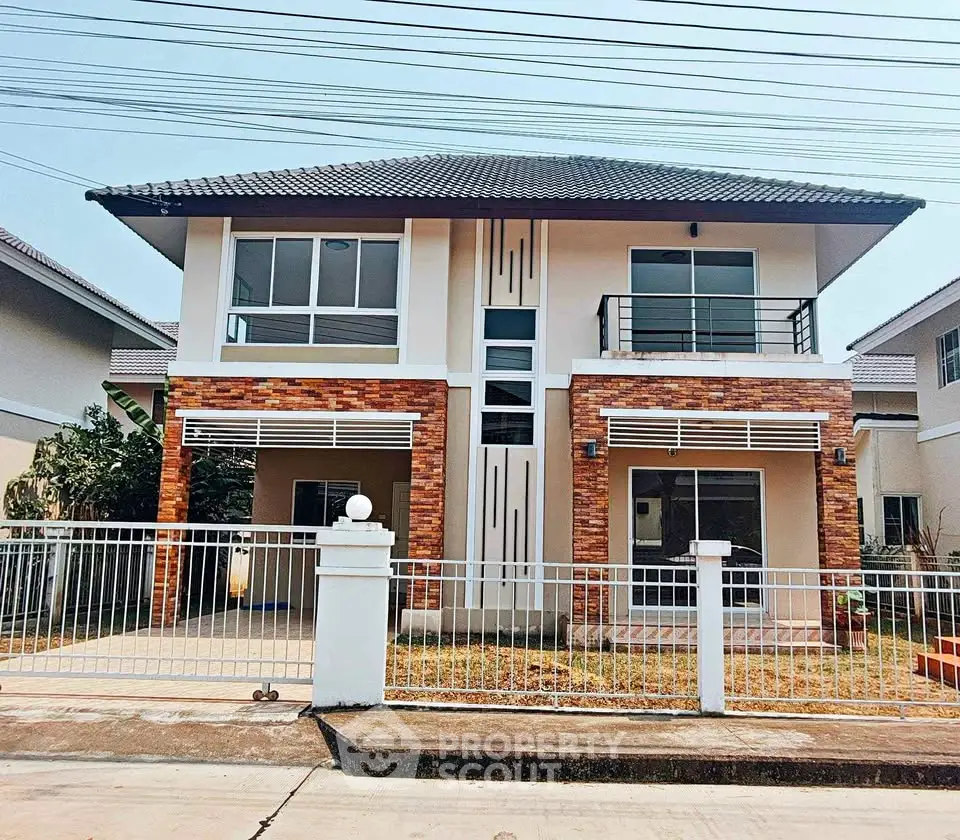 Modern two-story house with brick accents and gated front yard