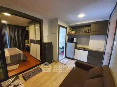 Cozy studio apartment with modern kitchen and bedroom view