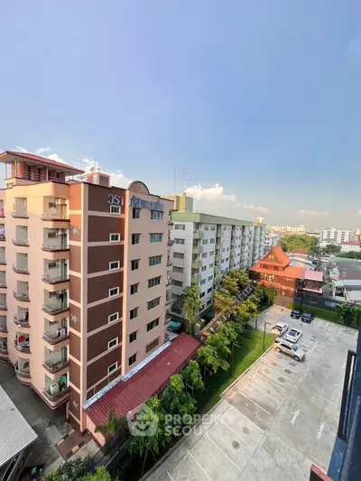 Stunning aerial view of residential buildings with spacious parking and lush greenery